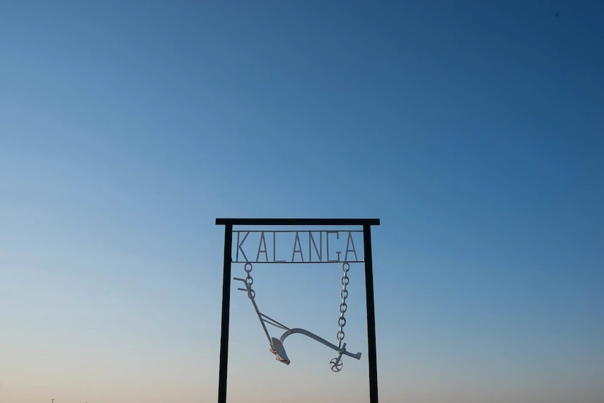 A hanging metal sign reading
