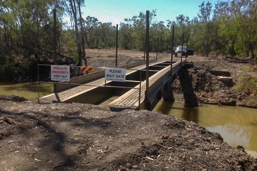 A bridge made from two long metal supports over the Macintyre river west of Goondiwindi.