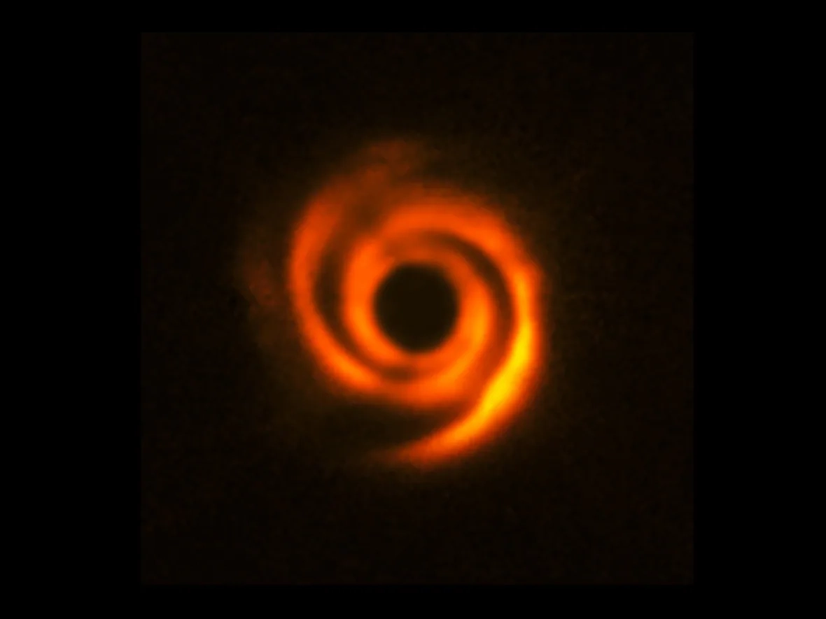 A bright orange and yellow swirl with a black background.