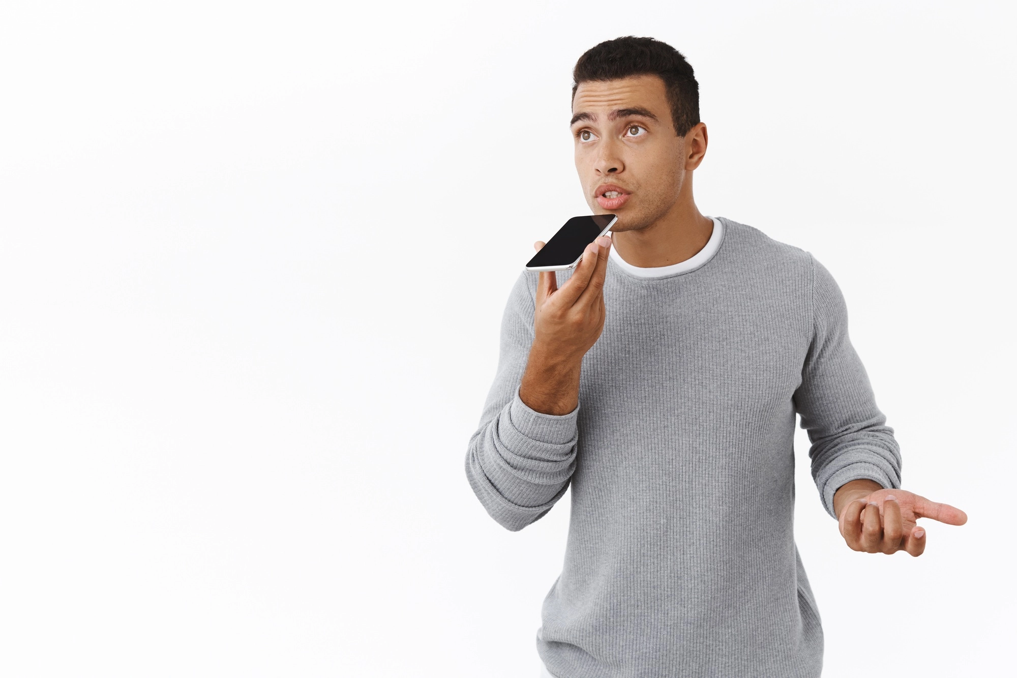 Young masculine, fit handsome businessman record voice message, talking to personal assistant