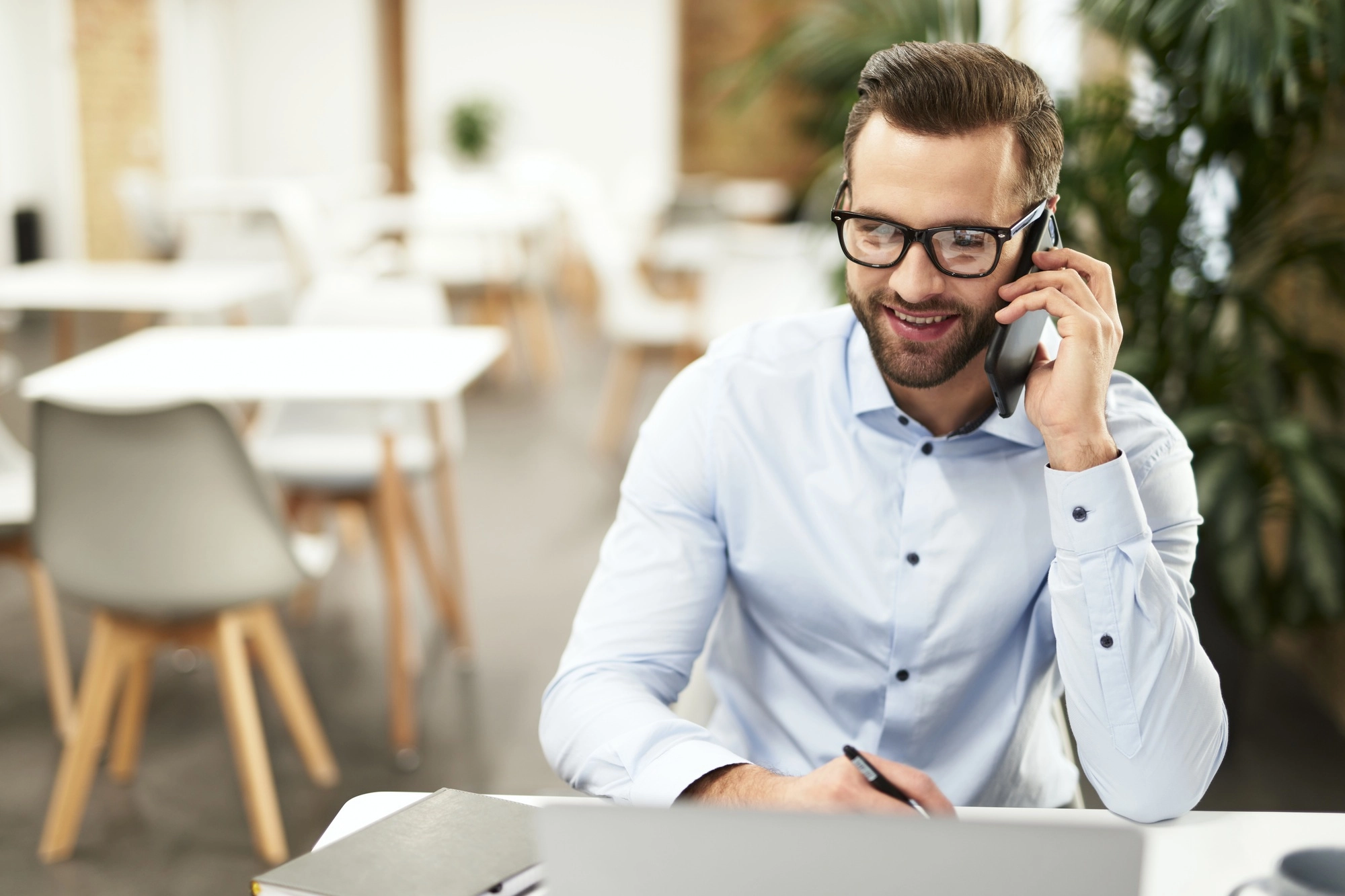 Confident office assistant answering the phone call