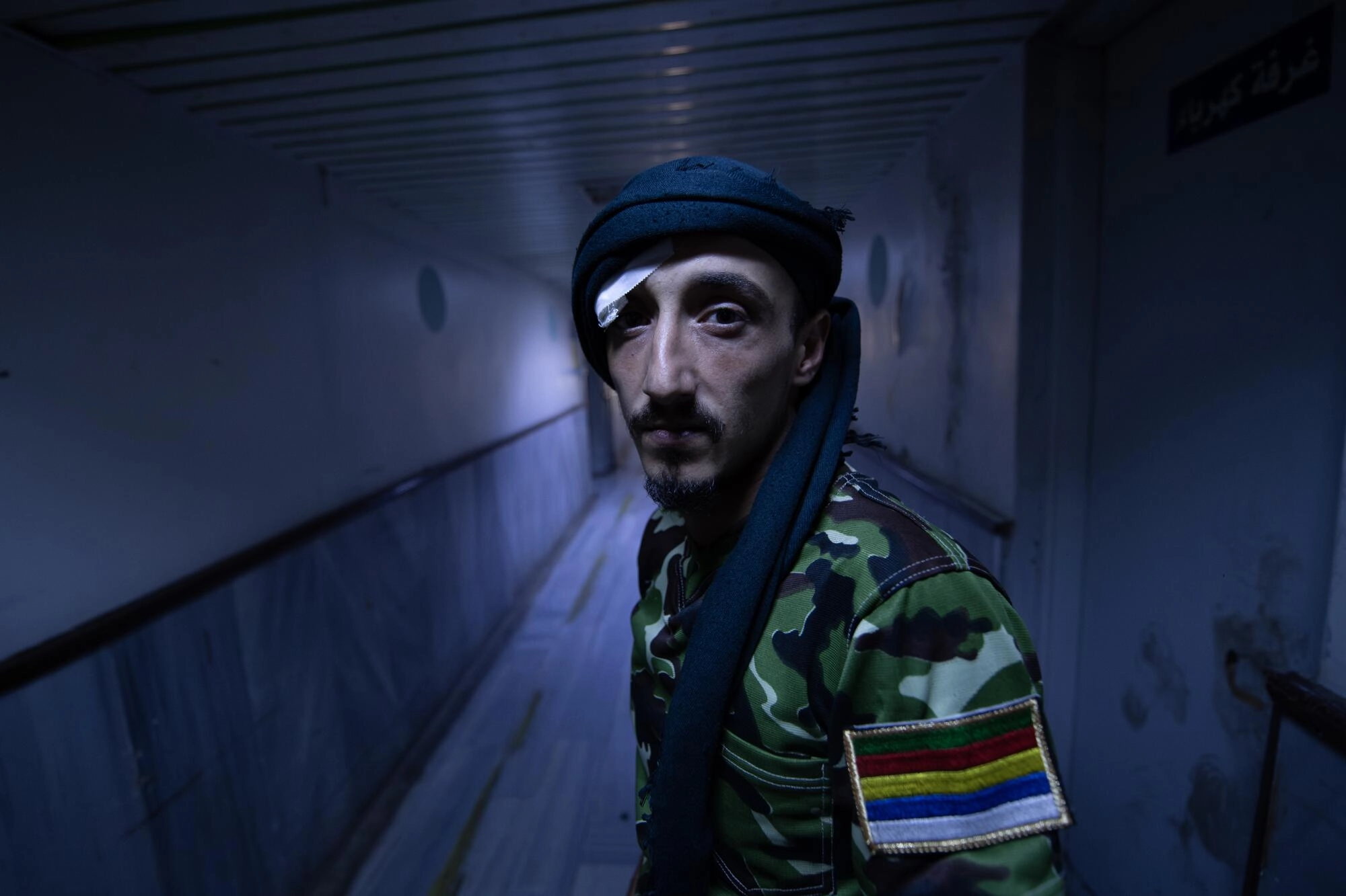A Druze fighter pauses for a photo in the hallway of the national hospital