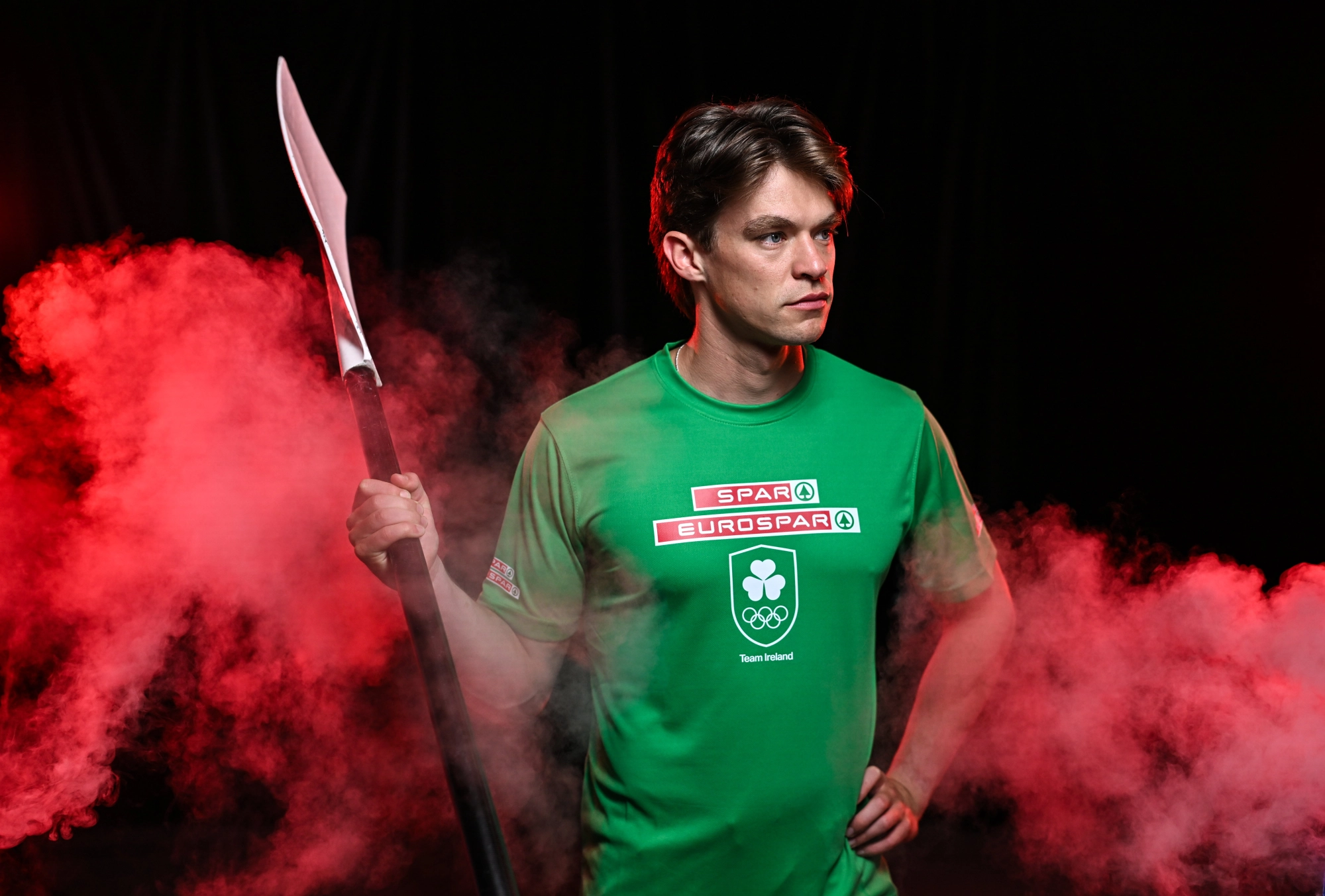 Fintan McCarthy, Irish Olympic rower, in Team Ireland uniform, holding an oar.