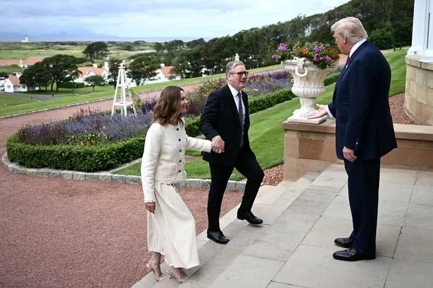 US President Donald Trump (R) greets Britain's Prime Minister Keir Starmer and his wife Victoria Starmer upon his arrival to attend a bilateral meeting at the Trump Turnberry Golf Courses, in Turnberry south west Scotland on July 28, 2025. (Photo by Brendan SMIALOWSKI / AFP) (Photo by BRENDAN SMIALOWSKI/AFP via Getty Images)