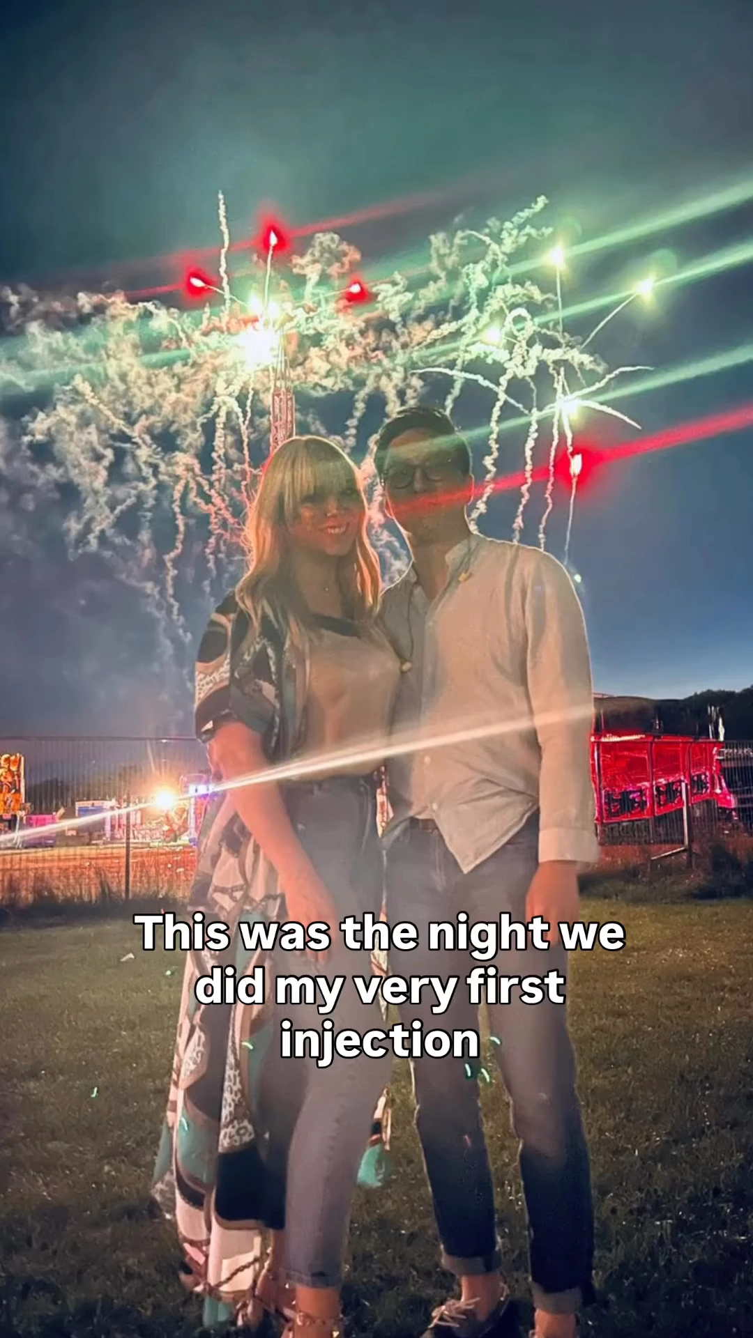 Couple standing in front of fireworks on the night of their first IVF injection.