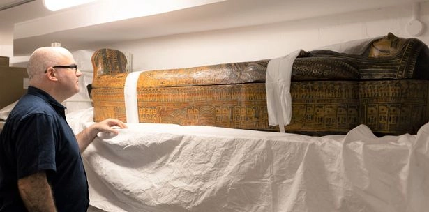 Dr Ken Griffin curator of the The Egypt Centre at Swansea University with an ancient Egyptian coffin from the pyramids at Luxor