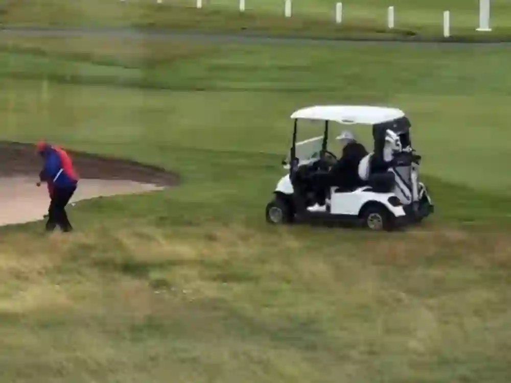 A caddie for Donald Trump appears to drop a ball in a better spot for the U.S. President to play in Scotland.
