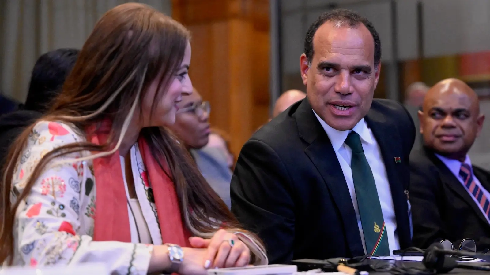 Chairperson of the African Union Commission on International Law, Hajer Gueldich (L) and Vanuatu's Climate Change Minister Ralph Regenvanu react ahead of the International Court of Justice (ICJ) session tasked with issuing the first Advisory Opinion (AO) on States' legal obligations to address climate change, in The Hague on July 23, 2025. The top UN court on July 23, 2025 described climate change as an 