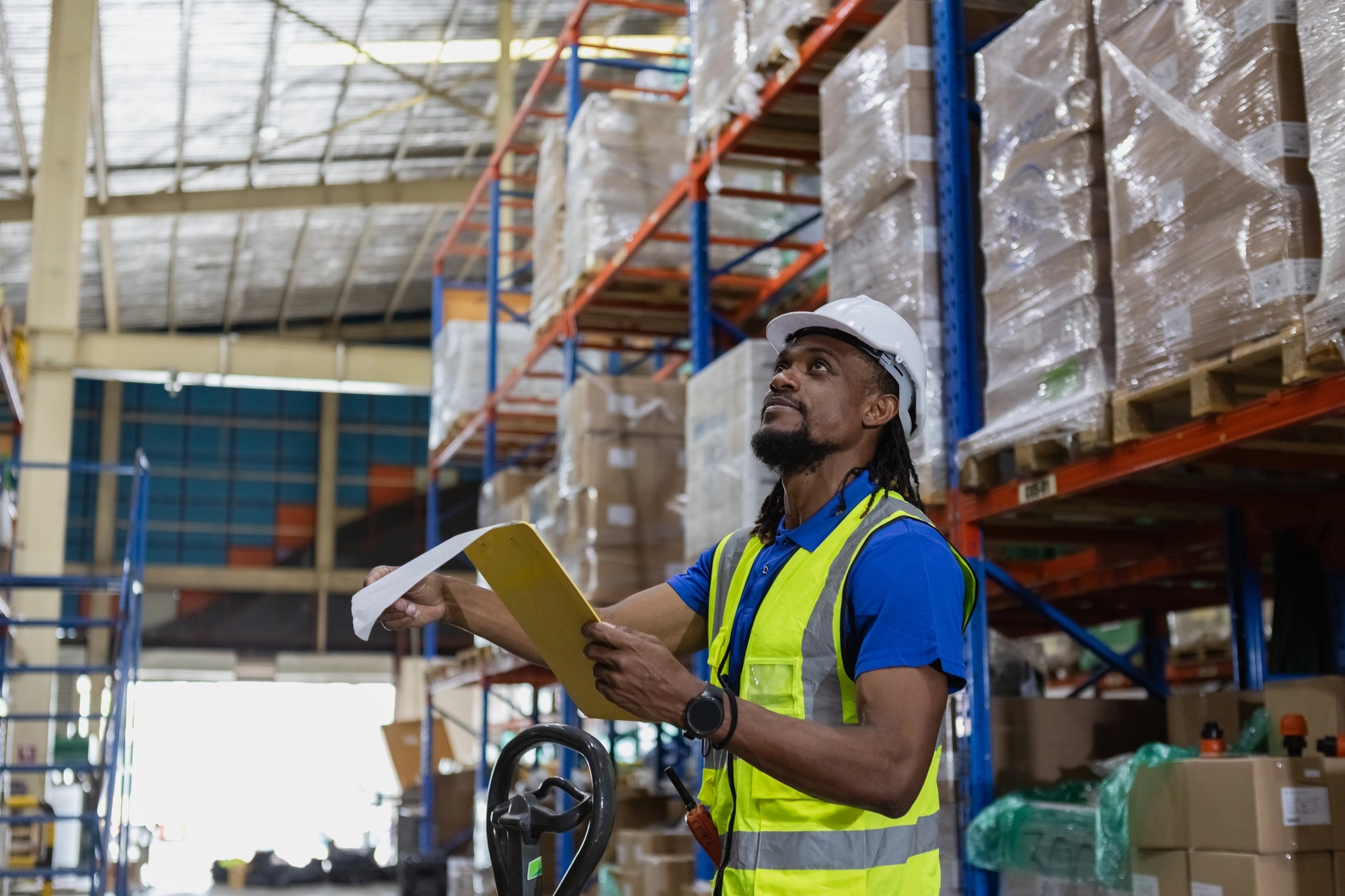 Warehouse industrial stock storage, Man African American worker wear safety uniform checklist stock
