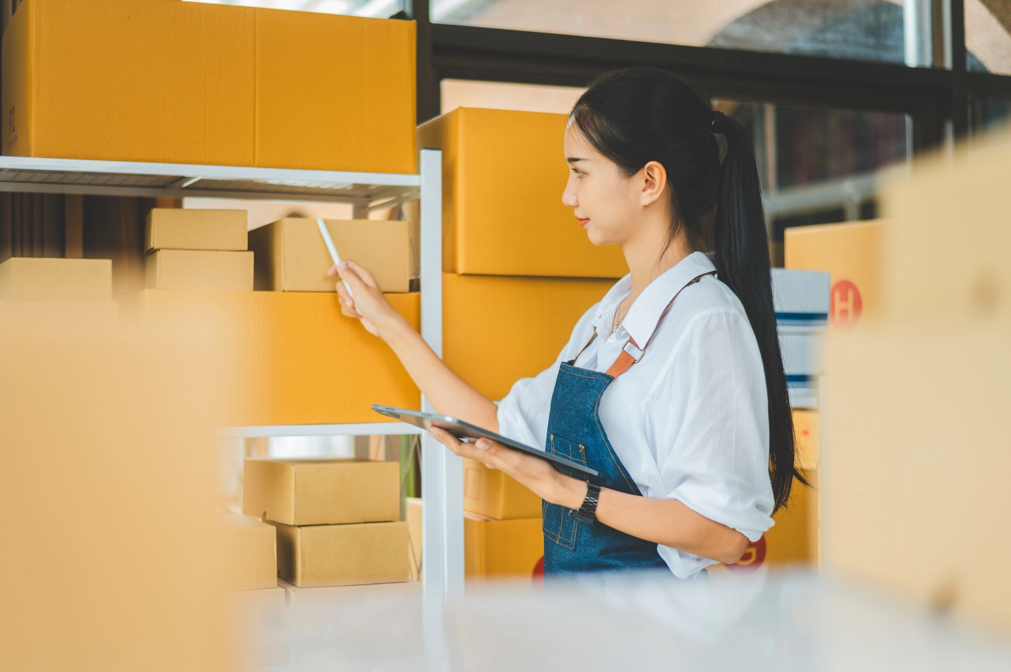 Small business owners online check stock on shelves, to calculate costs or check products