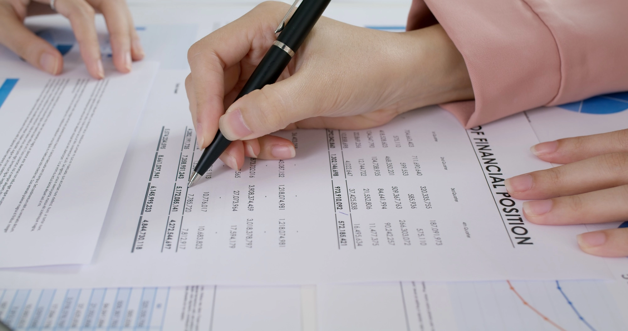 Close-up people hand of female stock trader use pen write on tax plan paper