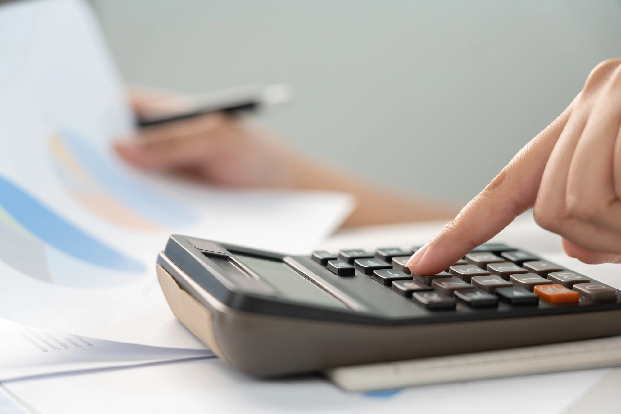 Businesswoman calculate budget with graph for business and finance data statistic project