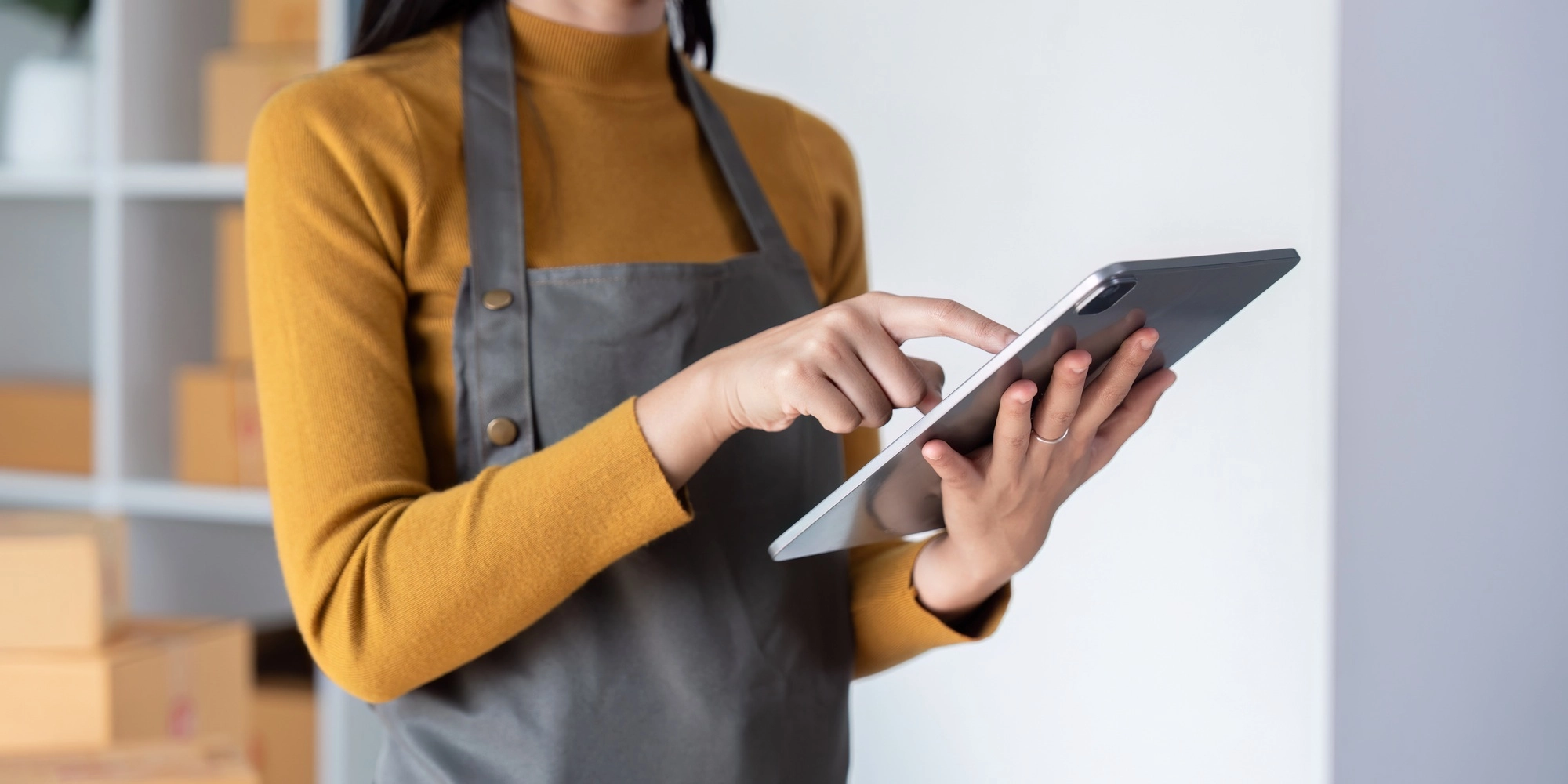 Woman using tablet to manage ecommerce inventory