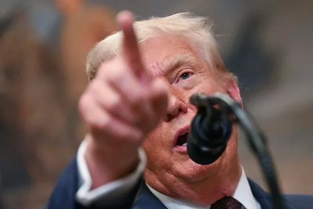 The US President points as he speaks after signing the executive order