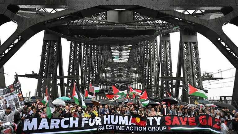 Protesters walk across the Sydney Harbour Bridge. Pic: AAP/Dean Lewins/Reuters