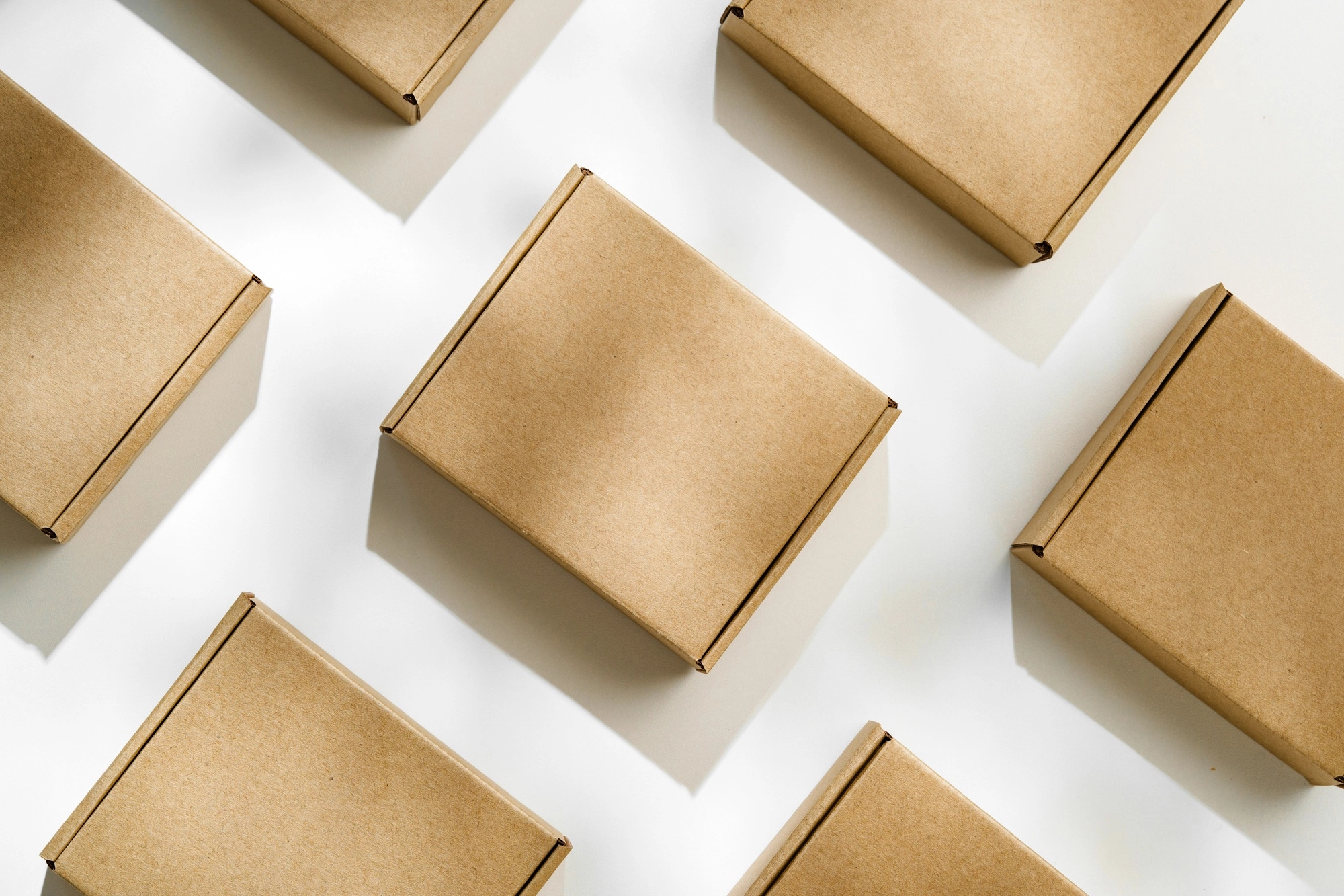 Brown cardboard boxes arranged on a light surface for packing goods in a warehouse setting