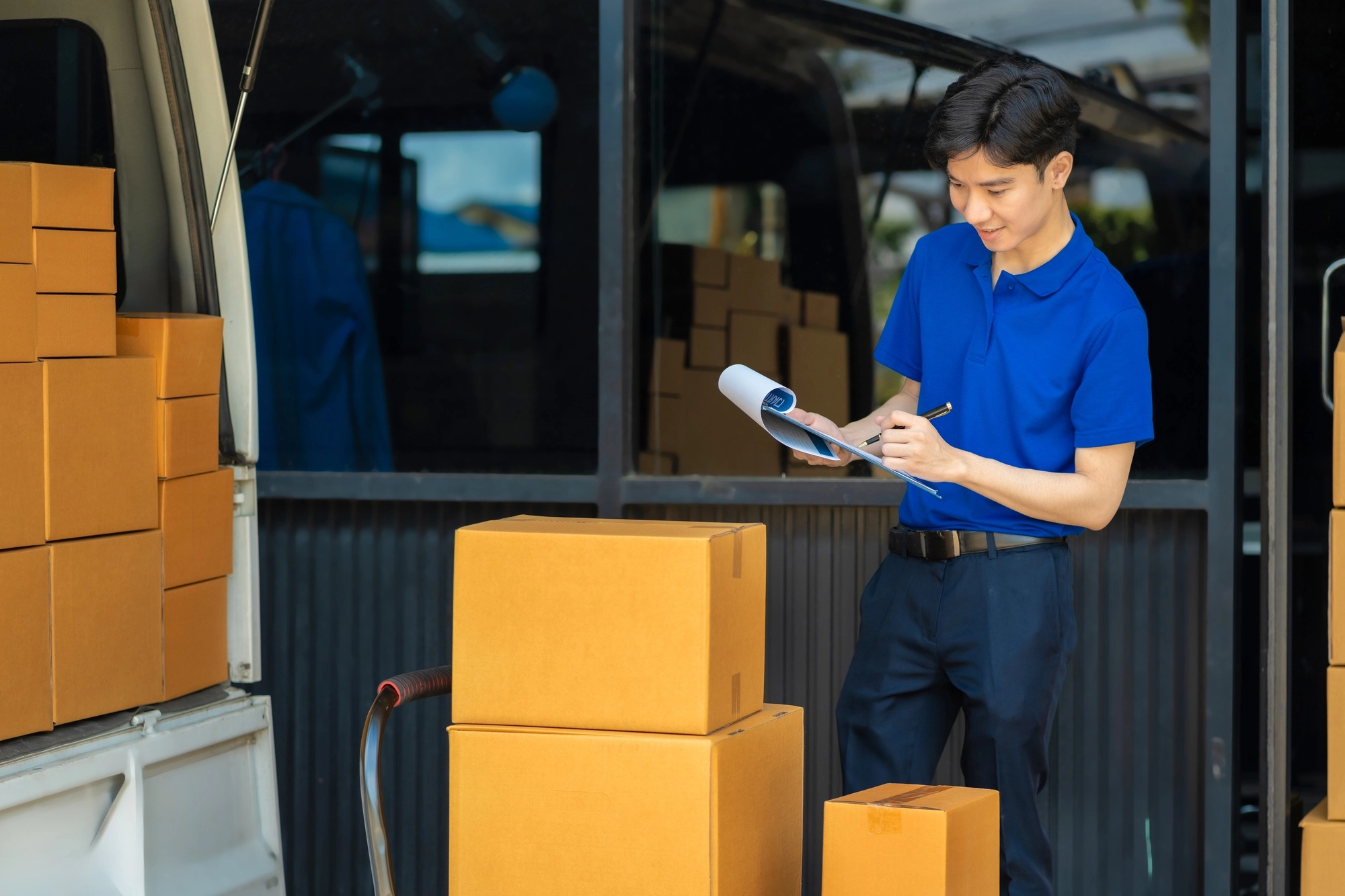 Asian delivery man work in truck for checking the product in the truck, concept ecommerce.