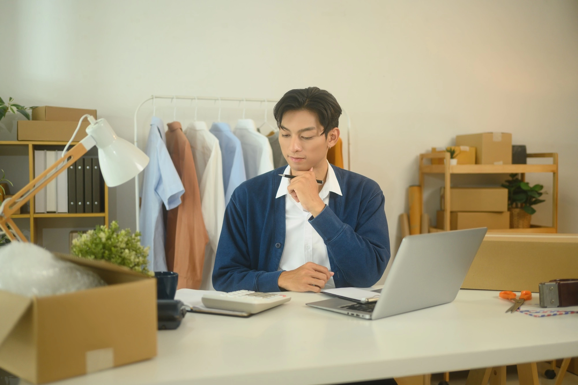 Focused online seller working on a laptop planning marketing strategies