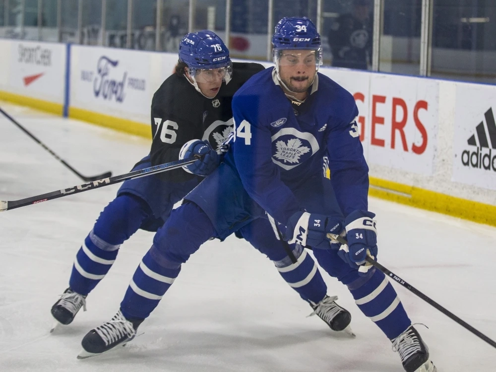 Toronto Maple Leafs' Auston Matthews (right) and William Villeneuve fight for the puck during training camp in 2023.