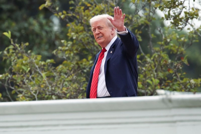 President Donald Trump gestures to the media from the roof of the West Wing at the White House on Tuesday morning. Photo by Samuel Corum/UPI