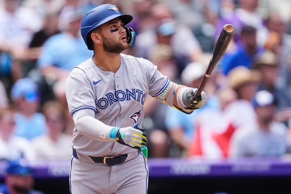 Blue Jays' Bo Bichette follows the flight of his three-run home run off Colorado Rockies pitcher Kyle Freeland in the third inning on Wednesday, Aug. 6, 2025, in Denver.
