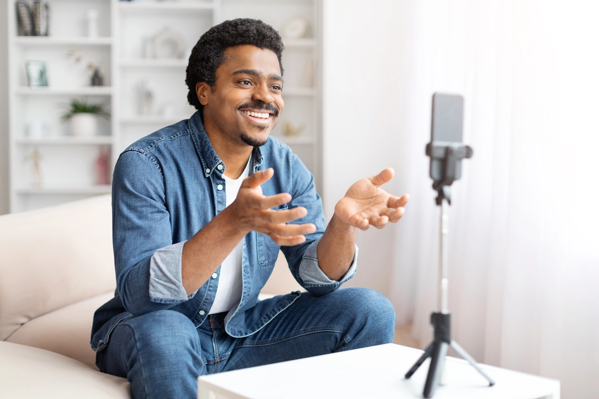 Man recording a video on smartphone at home