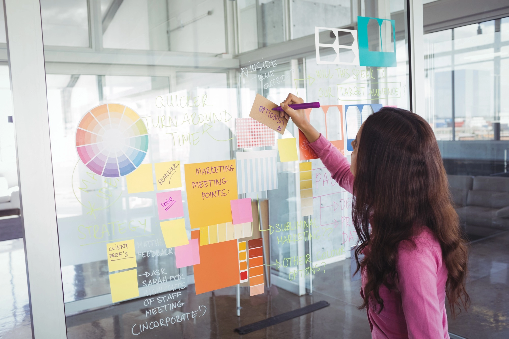 Designer making strategy on glass in creative office