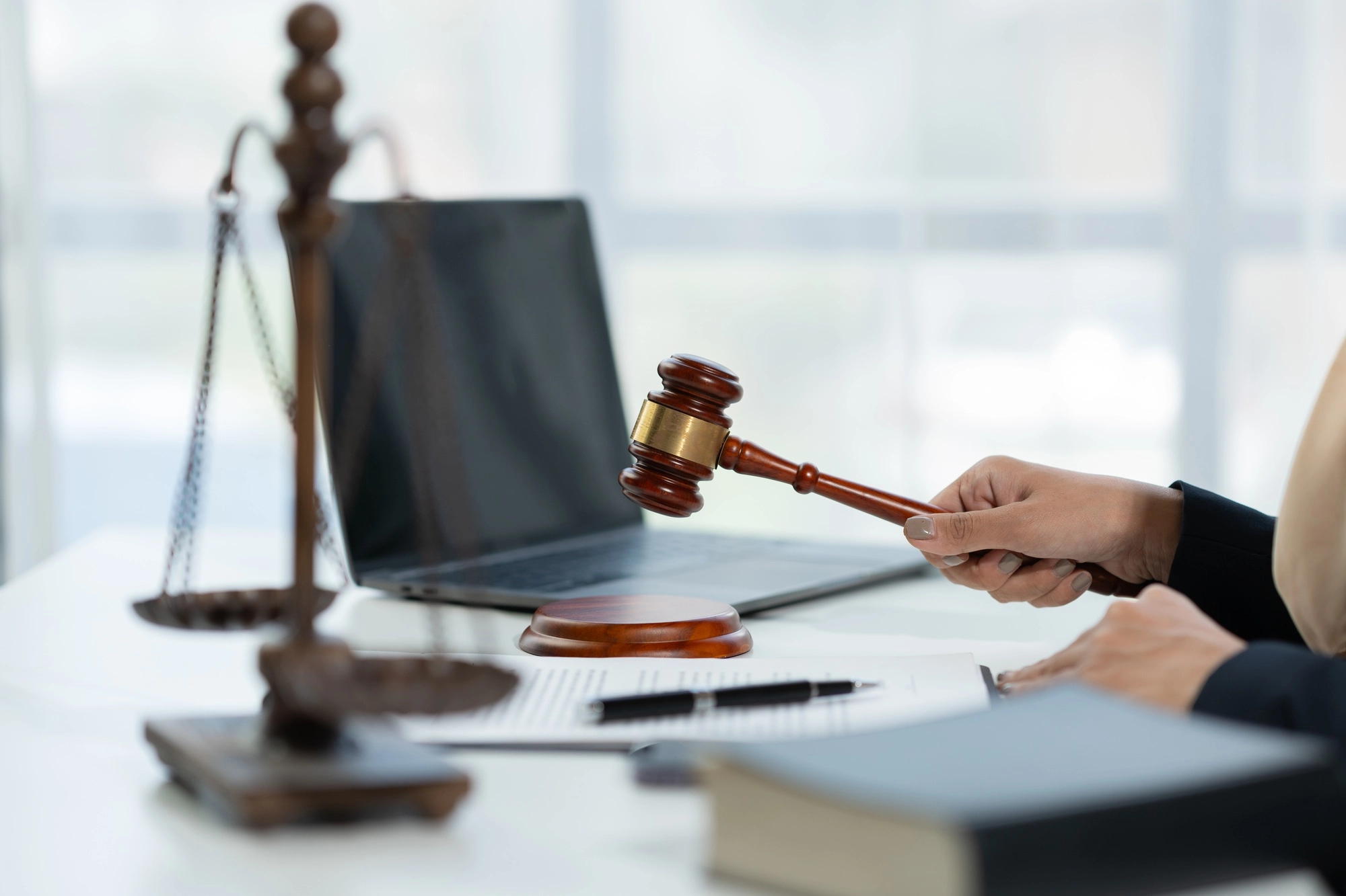 female Muslim lawyer wearing hijab holding the hammer of justice Summary of business contract legal