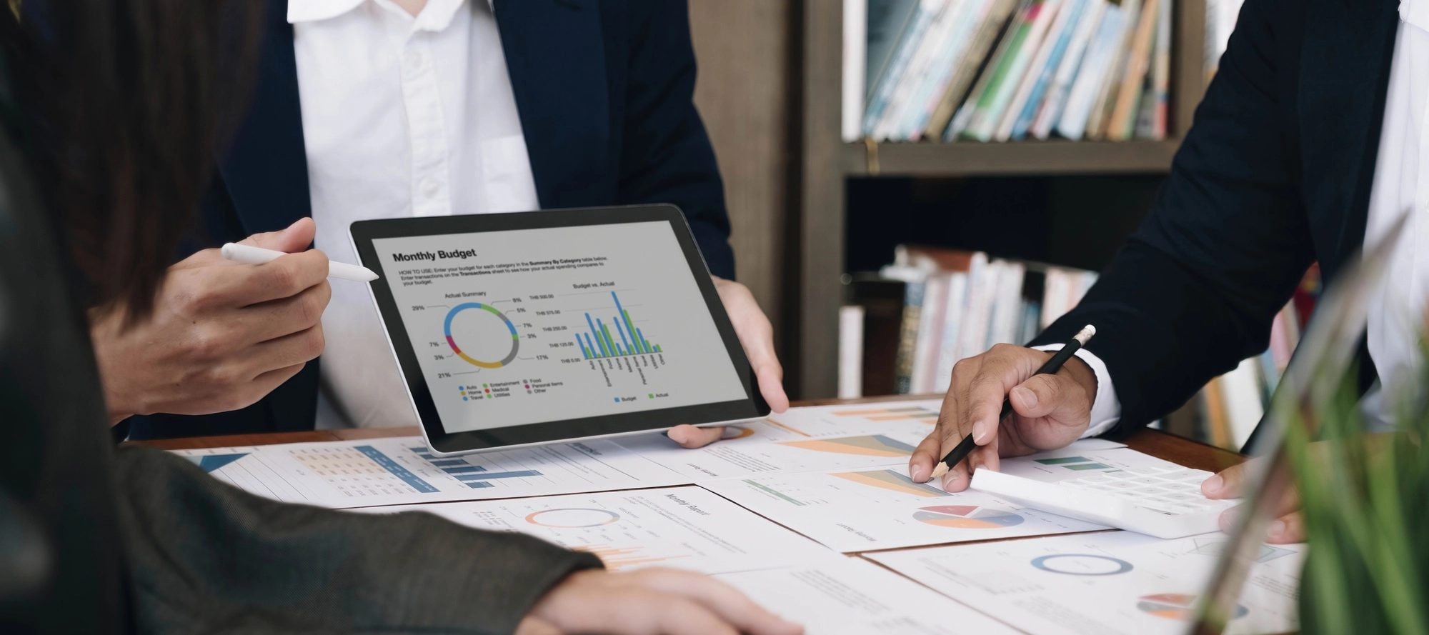 Business team analyzing income charts and graphs with modern laptop computer. Close up.Business