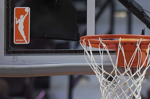 The WNBA logo is seen near a hoop before an WNBA basketball game at Mohegan Sun Arena, Tuesday, May 14, 2019, in Uncasville, Conn. (AP Photo/Jessica Hill, File)