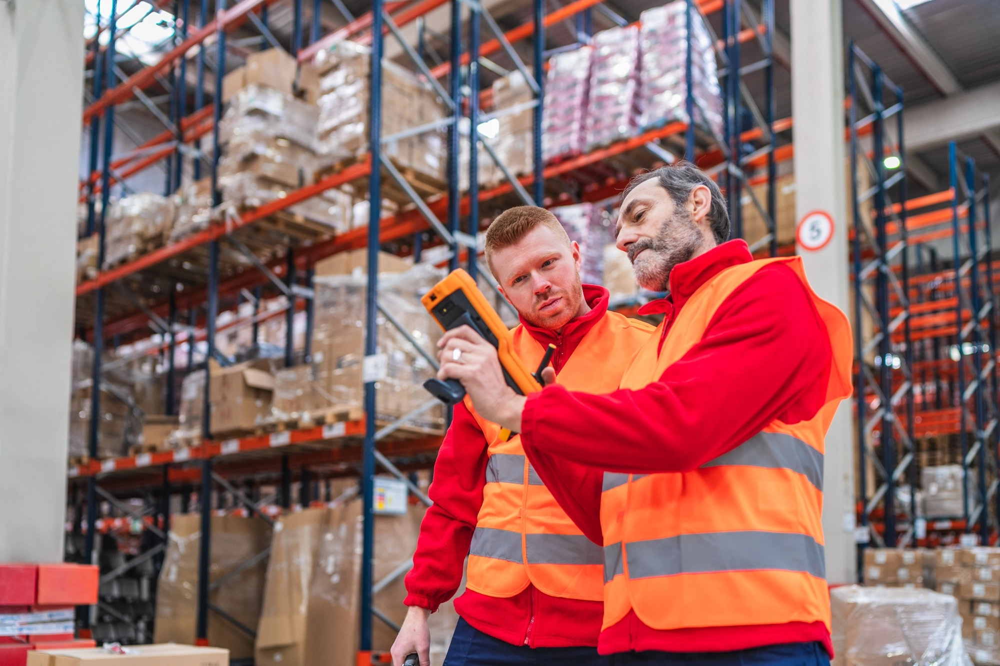 Warehouse workers using barcode scanner for inventory management