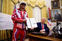 U.S. President Donald Trump, accompanied by entertainer Kid Rock, signs an executive order in the Oval Office of the White House on March 31, 2025 in Washington, DC.