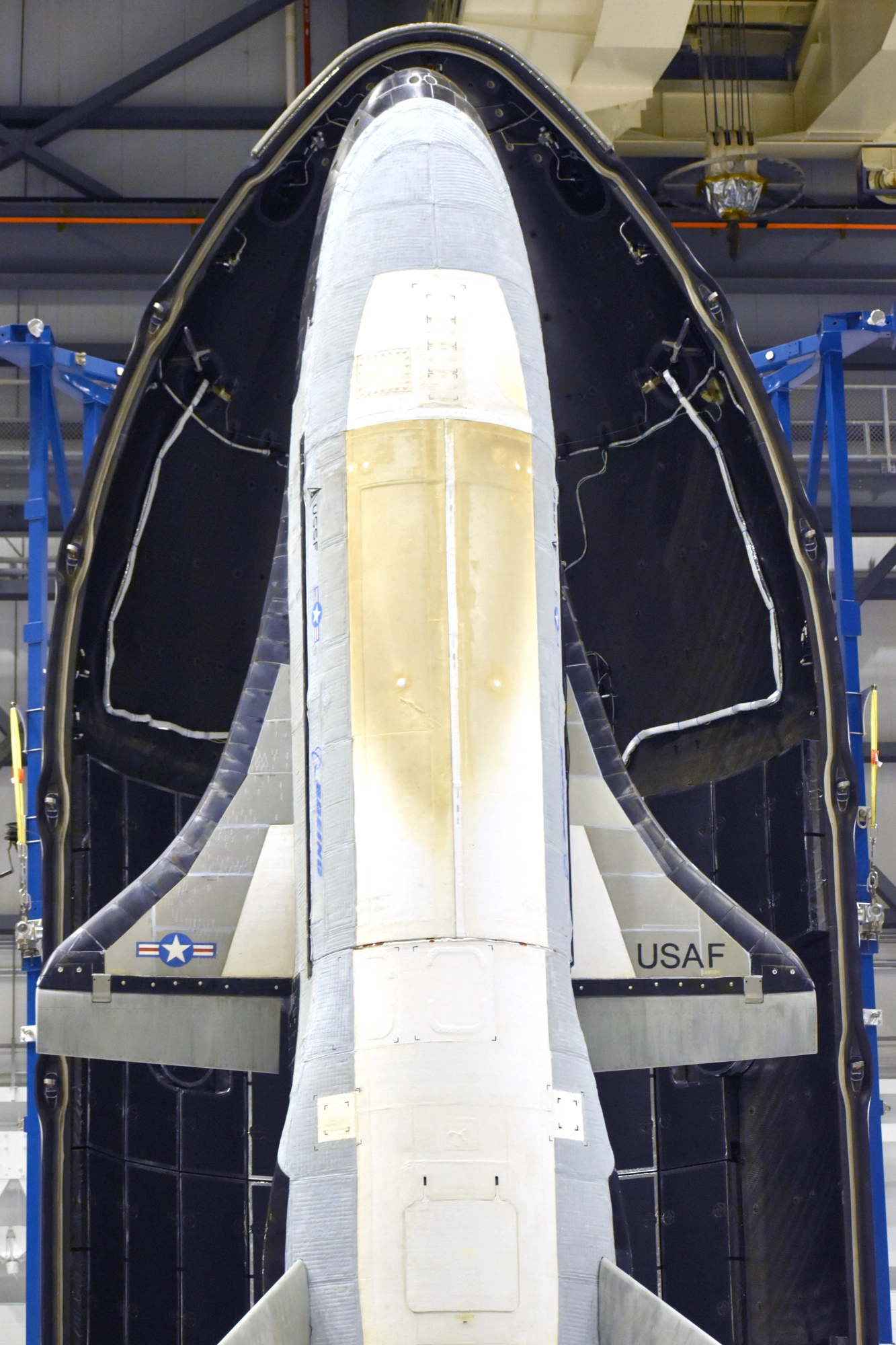 a white aircraft inside of a large egg-shaped pod in a hangar