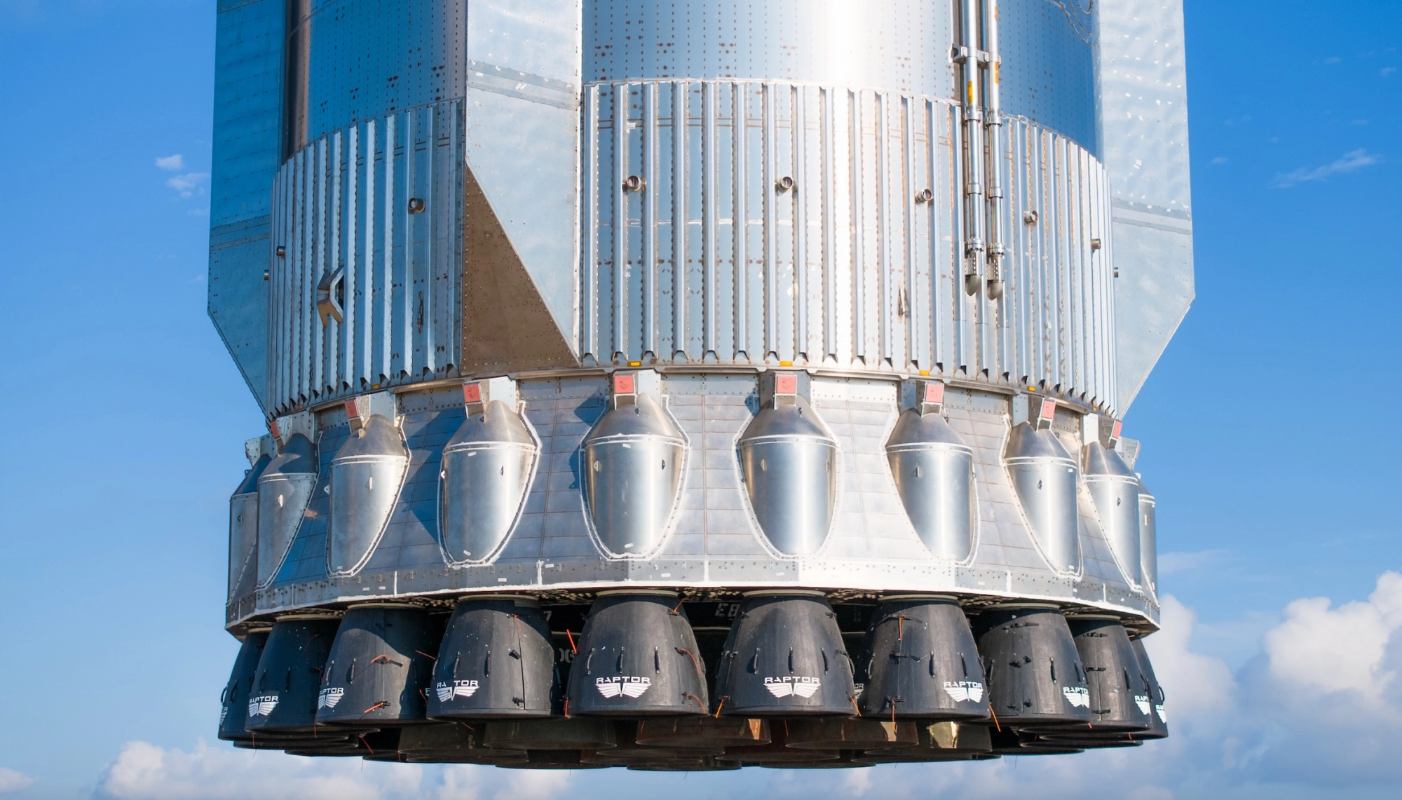closeup of the engines of a large silver rocket