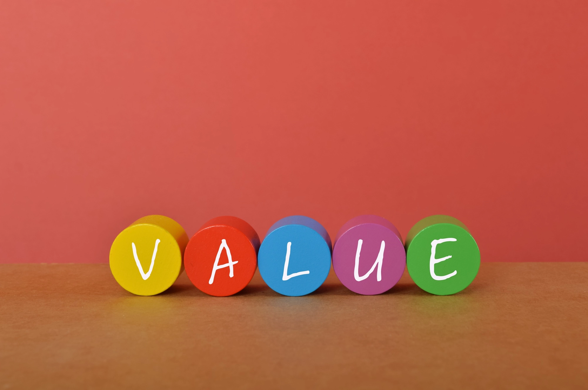 Colorful wooden blocks with text VALUE. Cost of goods sold concept.
