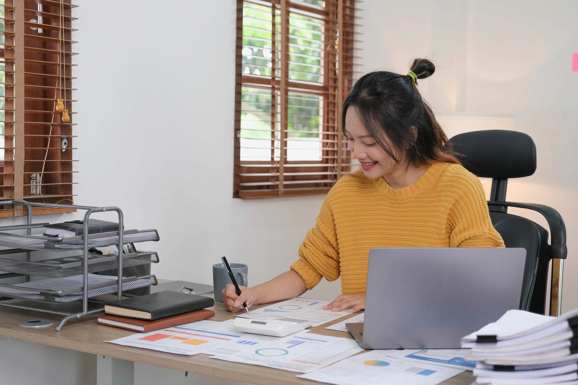 Asian Businessman working to analyze technical price graph and indicator. account or saving money or