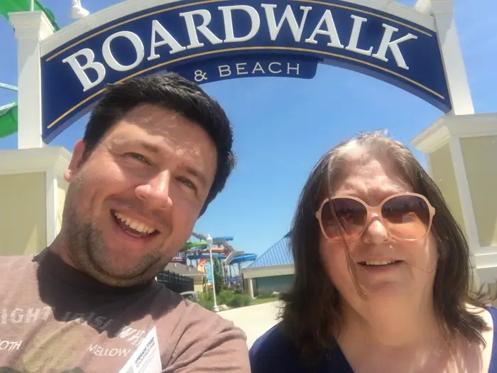The author and his mother posse on a beach boardwalk.